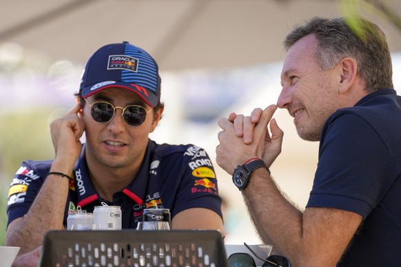 Red Bull team principal Christian Horner, right, chats with Red Bull driver Sergio Perez of Mexico at the pits during Formula One pre season test at the Bahrain International Circuit in Sakhir, Bahrai ...