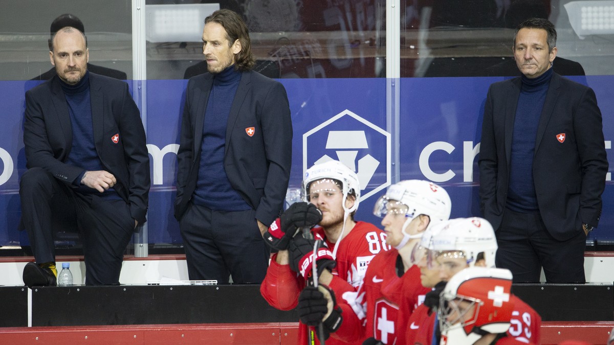 epa09245472 Switzerland's head coach Patrick Fischer (2-L) and his assistants Christian Wohlwend (L) and Marco Bayer (R) react after the IIHF Ice Hockey World Championship 2021 quarter final game ...