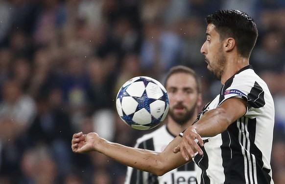 FILE - In this April 11, 2017 file photo, Juventus&#039;s Sami Khedira goes for the ball during a Champions League match between Juventus and Barcelona, at the Juventus Stadium in Turin, Italy. German ...