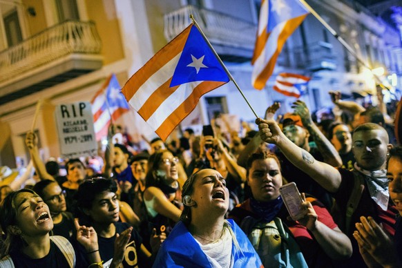 Demonstrators protest against Gov. Ricardo Rossello in San Juan, Puerto Rico, Tuesday, July 23, 2019. Protesters are demanding Rossello step down for his involvement in a private chat in which I used  ...