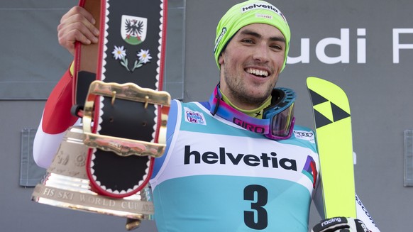 Winner Daniel Yule of Switzerland celebrates with the trophy, a cow bell, on the podium after the men&#039;s slalom FIS World Cup race in Adelboden, Switzerland, Sunday, January 12, 2020. (KEYSTONE/Pe ...