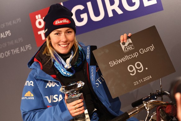 epa11736372 Mikaela Shiffrin of United States sits on a motorbike in the press centre and poses with her trophy after winning the Women&#039;s Slalom race of the FIS Alpine Skiing World Cup in Gurgl,  ...