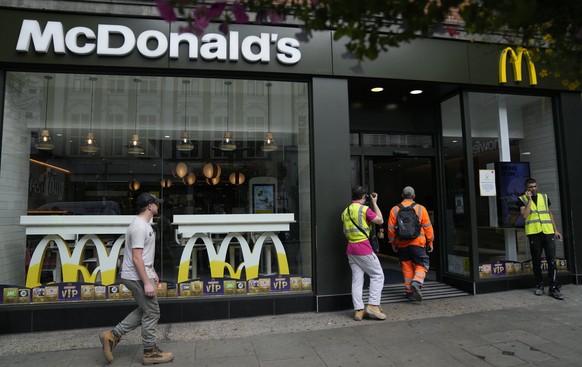 Customers walks into a branch of a McDonald&#039;s restaurant, in London, Tuesday, Aug. 24, 2021. McDonald���s says it has pulled milkshakes from the menu in all 1,250 of its British restaurants becau ...