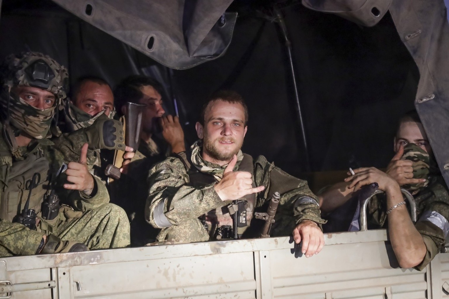 Members of the Wagner Group military company sit in their vehicle on a street in Rostov-on-Don, Russia, Saturday, June 24, 2023, as they prepare to leave an area near the headquarters of the Southern Mi…