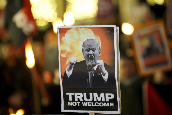 epa06468518 A placard with US President Donald J. Trump porrtrait is seen during the demonstration &#039;Trump not welcome!&#039; against the upcoming visit of US President Donald Trump at the World E ...