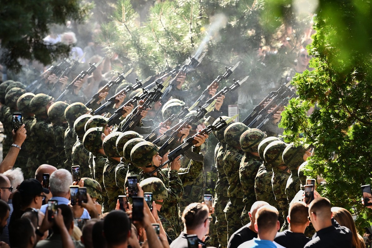 Serbian national military servicemen fire a three-volley salute during the funeral of former Bosnian Serb army commander Ratko Mladic, who died last week while serving a life sentence for genocide and ...