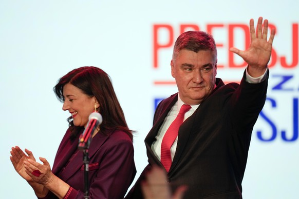 Incumbent president and presidential candidate Zoran Milanovic, right, greets supporters after his headquarters claimed victory in elections in Zagreb, Croatia, Sunday, Dec. 29, 2024. (AP Photo/Darko  ...