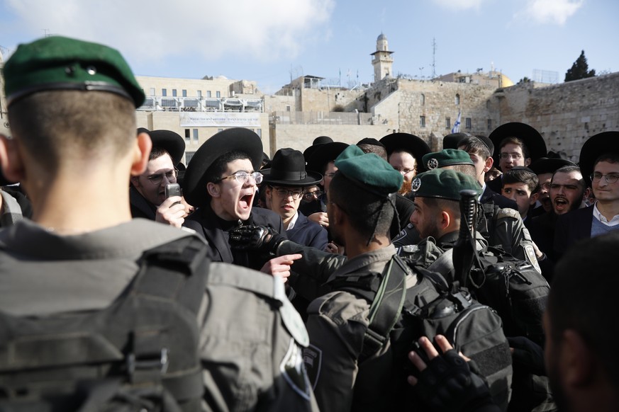 epa07421379 Israeli border police scruffle with ultra-Orthodox Jews protesting against members of the &#039;Women of the Wall&#039; feminist organization gathering for the monthly Rosh Hodesh, or &#03 ...