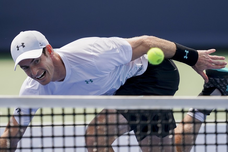 Andy Murray, of Great Britain, returns to Lucas Pouille, of France, in the first round at the Western &amp; Southern Open, Monday, Aug. 13, 2018, in Mason, Ohio. (AP Photo/John Minchillo)