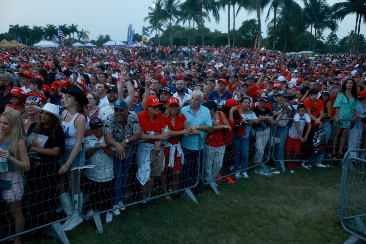 DORAL, FLORIDA - JULY 09: People listen to former U.S. President Donald Trump speak at a campaign rally at the Trump National Doral Golf Club on July 09, 2024 in Doral, Florida. Trump continues to cam ...