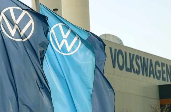 FILE - Company logo flags wave in front of a Volkswagen factory building in Zwickau, Germany, on April 23, 2020. European governments are contemplating new sanctions against Russia if it invades Ukrai ...
