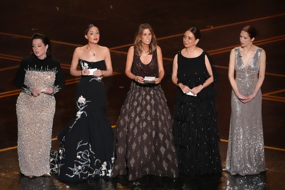 Melissa McCarthy, from left, Rose Byrne, Kristen Wiig, Maya Rudolph, and Ellie Kemper present the award for best original score during the Oscars on Sunday, March 15, 2026, at the Dolby Theatre in Los ...