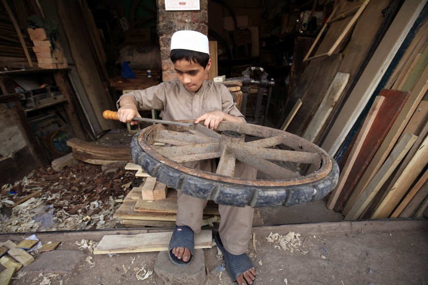 epa06024209 A boy works at a carpenter shop as world observes day against Child Labor in Peshawar, Pakistan, 12 June 2017. World Day Against Child Labor is observed on 12 June across the world includi ...