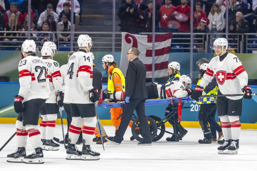 Injured Switzerland's Kevin Fiala #21, injured, is stretchered on a stretcher off the ice by paramedics, during the men's group A preliminary round game between Canada and Switzerland at the ...