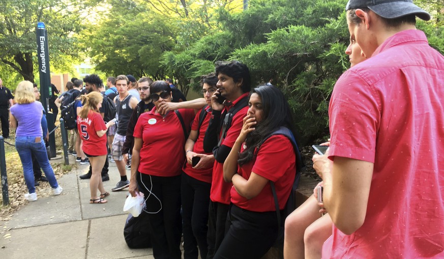 Students gather on the campus of the University of North Carolina Charlotte after a shooting Tuesday afternoon, April 30, 2019, in Charlotte, N.C. (John Simmons/The Charlotte Observer via AP)