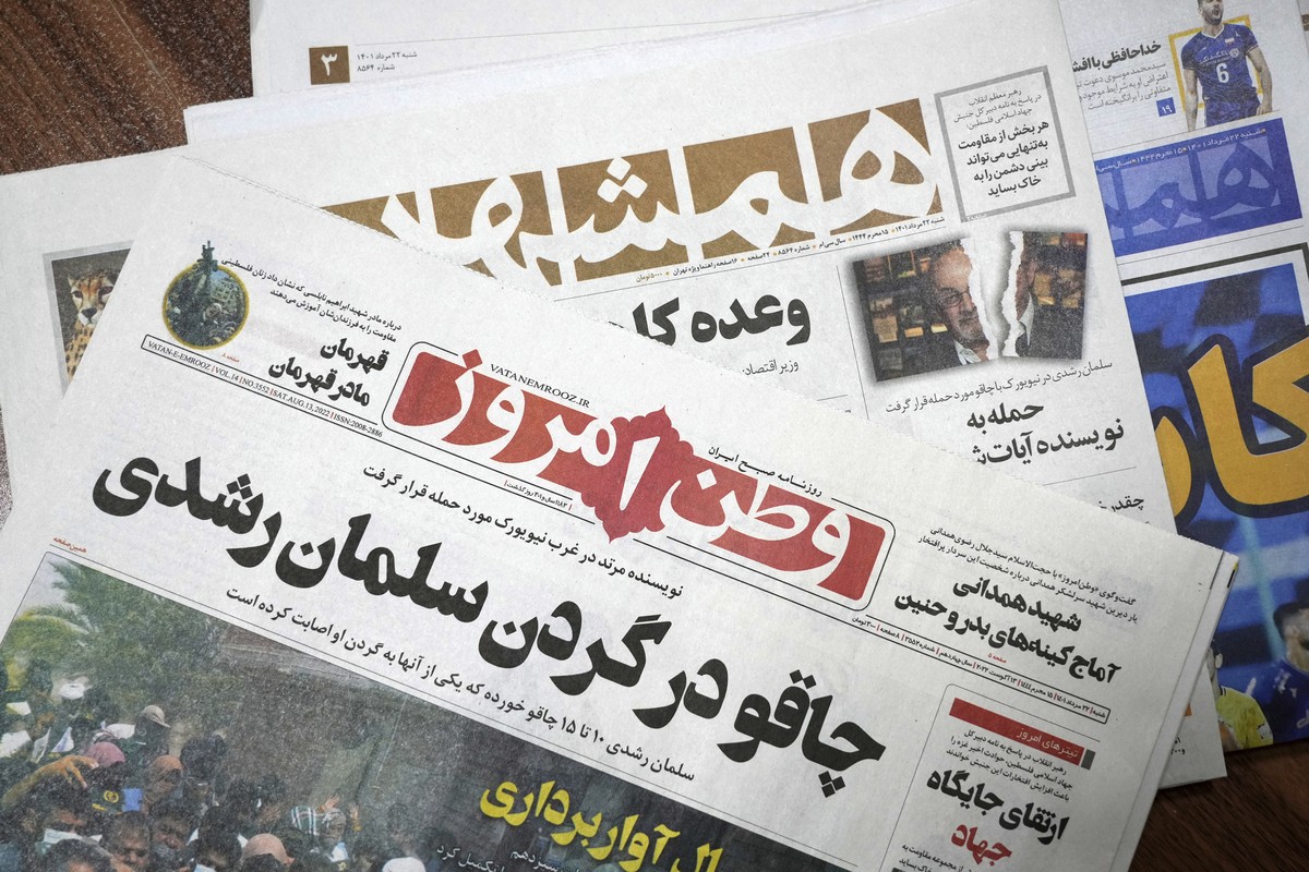 The front pages of the Aug. 13 edition of the Iranian newspapers, Vatan-e Emrooz, front, with title reading in Farsi: "Knife in the neck of Salman Rushdie," and Hamshahri, rear, with title:  ...