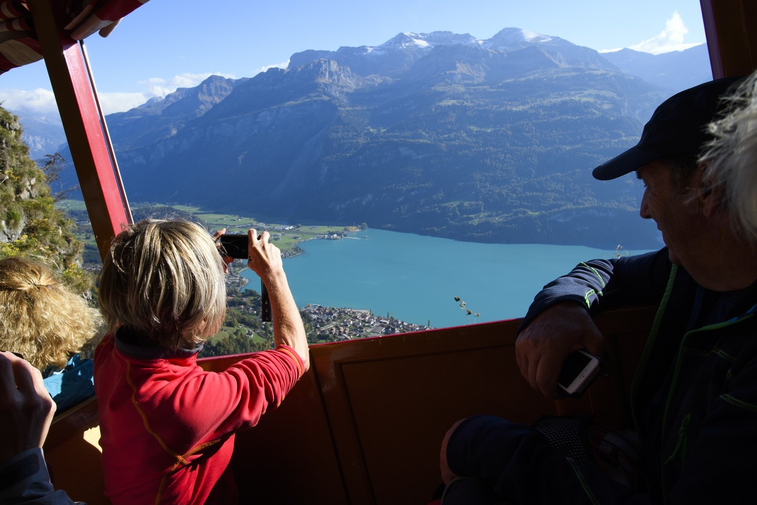 People enjoy the view from the Brienz Rothorn Railway, in the Bernese Alps in the Cantons of Berne, Switzerland, on Wednesday, October 10, 2018. (KEYSTONE/Anthony Anex)