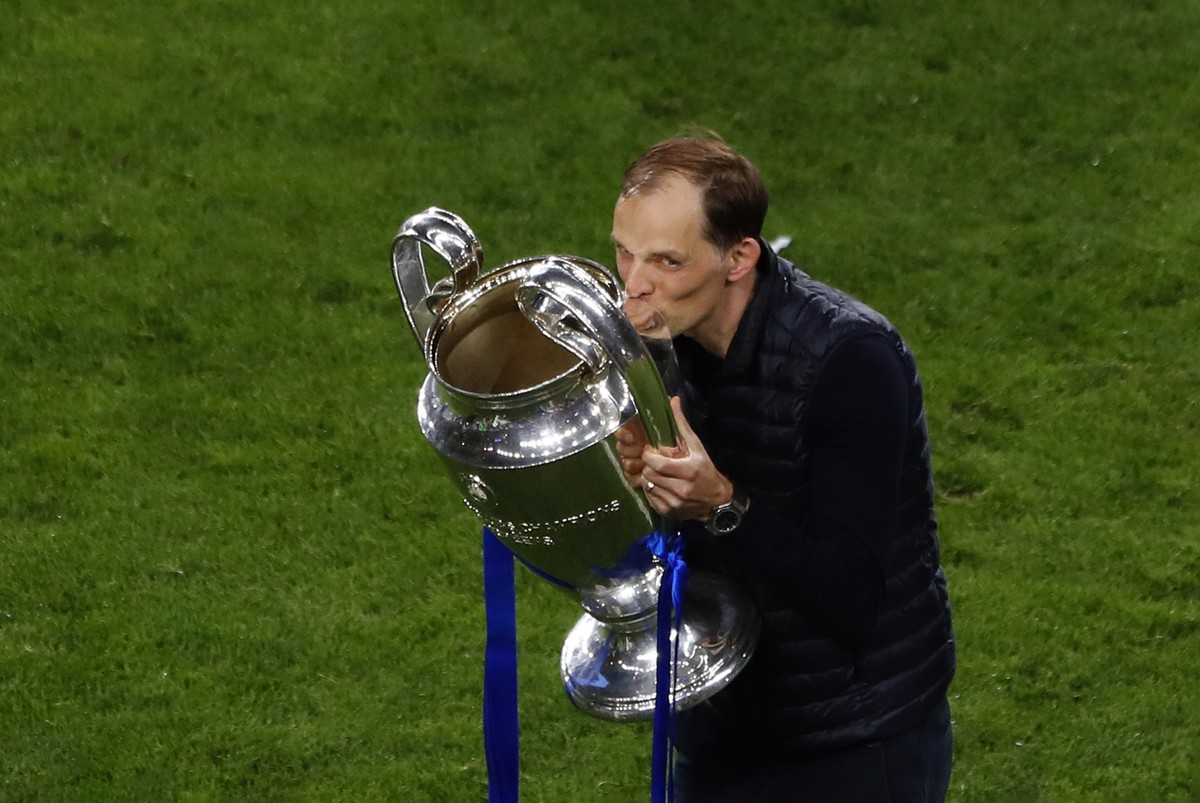 Chelsea's head coach Thomas Tuchel celebrates kissing the trophy after winning the Champions League final soccer match against Manchester City at the Dragao Stadium in Porto, Portugal, Saturday,  ...