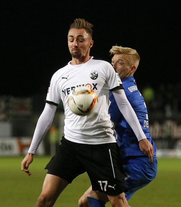 SANDHAUSEN, GERMANY - DECEMBER 11: Florian Huebner of Sandhausen (L) and Saulo Decarli of Braunschweig compete for the ball during the Second Bundesliga match between SV Sandhausen and Eintracht Braun ...