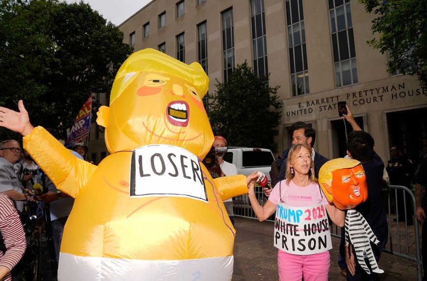 WASHINGTON, DC - AUGUST 03: A person dressed in a costume depicting former U.S. President Donald Trump as a baby walks in front of the E. Barrett Prettyman United States Courthouse on August 03, 2023  ...