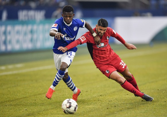 Freiburg's Vincenzo Grifo, right, and Schalke's Rabbi Matondo challenge for the ball during the German Bundesliga soccer match between FC Schalke 04 and SC Freiburg in Gelsenkirchen, Germany ...