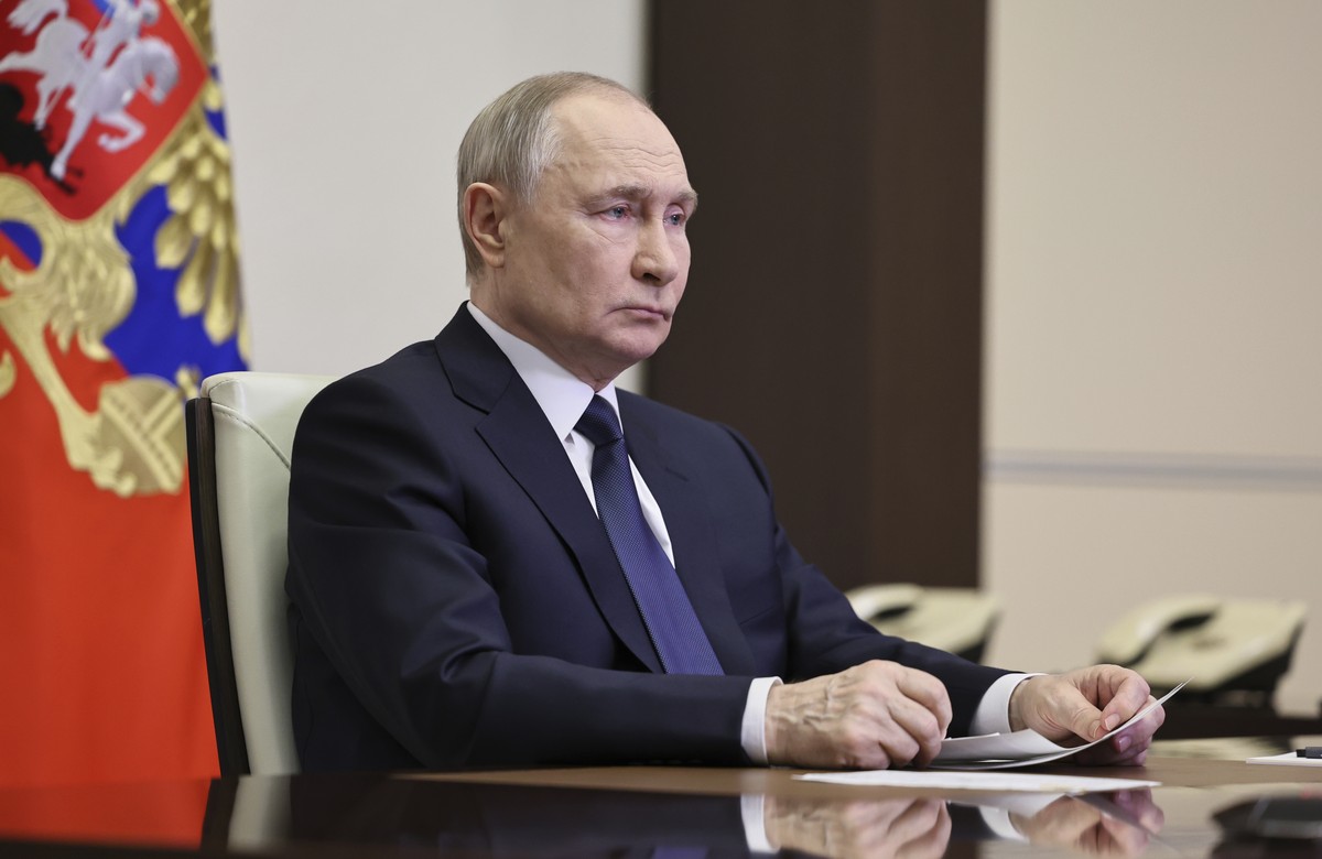 Russian President Vladimir Putin listens to Russian Chief of General Staff Gen. Valery Gerasimov with the report that all Ukrainian troops have been forced from Russia's Kursk region, during thei ...