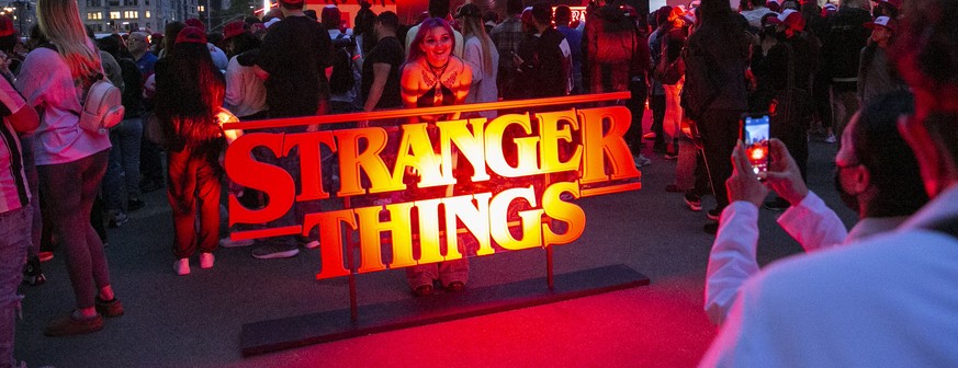 epa09978918 A fan poses for a picture before the video spectacle of Stranger Things season 4 that will be projected on the Empire State Building in New York, New York, USA, 26 May 2022. The long await ...