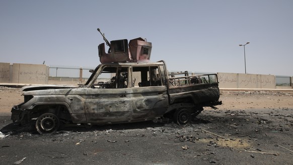 A destroyed military vehicle is seen in southern in Khartoum, Sudan, Thursday, April 20, 2023. The latest attempt at a cease-fire between the rival Sudanese forces faltered as gunfire rattled the capi ...