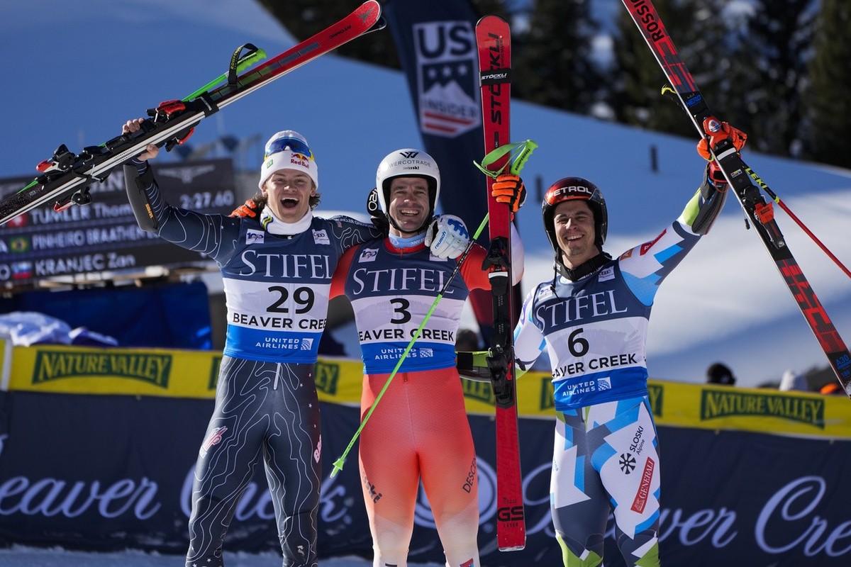 From left, second place finisher Brazil's Lucas Pinheiro Braathen, first place finisher Switzerland's Thomas Tumler, and third place finisher Slovenia's Zan Kranjec celebrate after a me ...