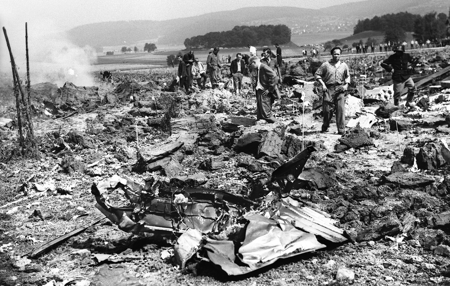 Rescue teams at the scene of the accident in the village of Duerrenaesch in the canton of Aargau, Switzerland, pictured in September 1963. The most severe accident in the history of Swiss aviation to  ...