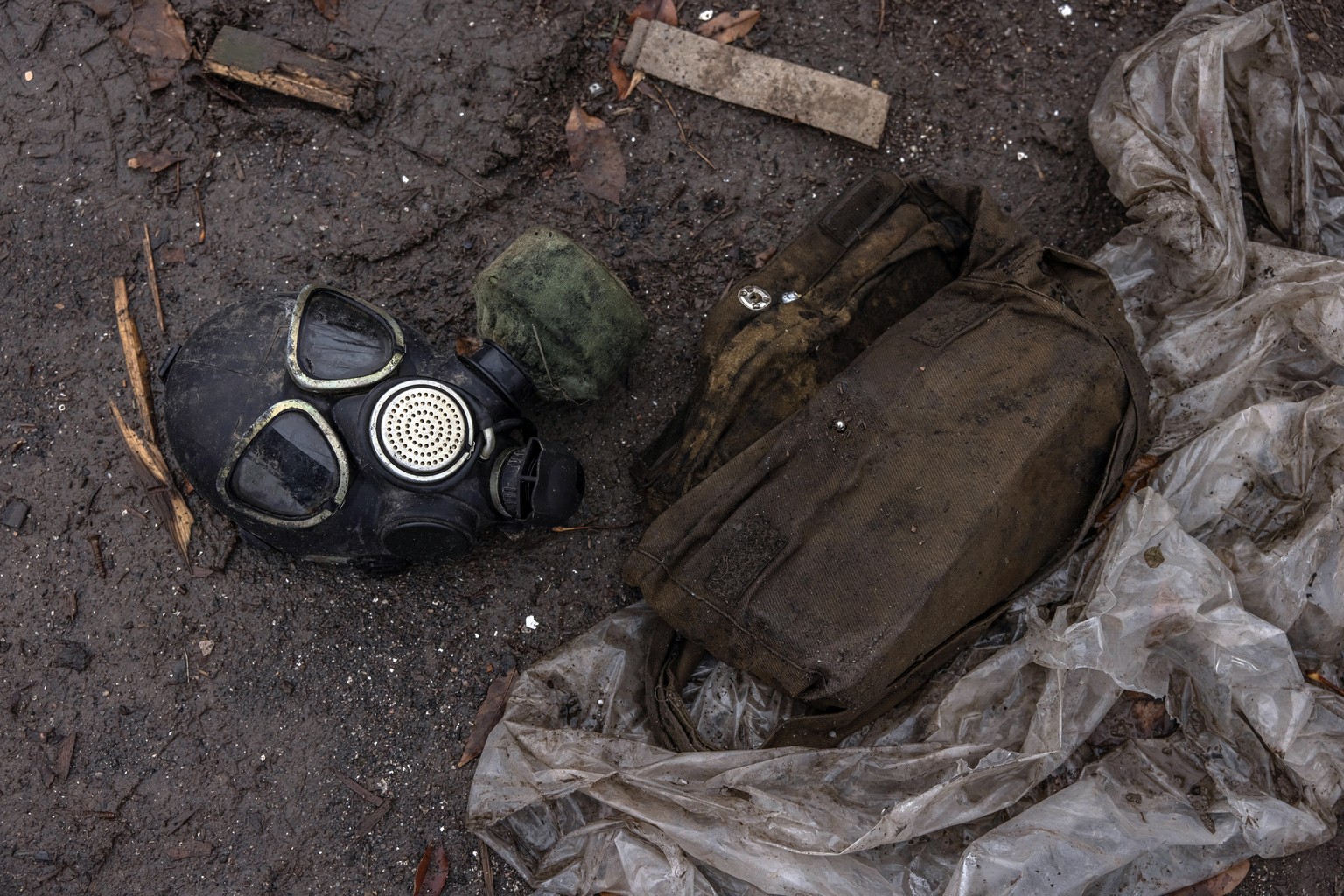 epa10326414 A gas mask of a Russian soldier lies on the ground at the territory of the international airport, after the Russian troops retreat from Kherson, in Chornobaivka village, outside Kherson, s ...