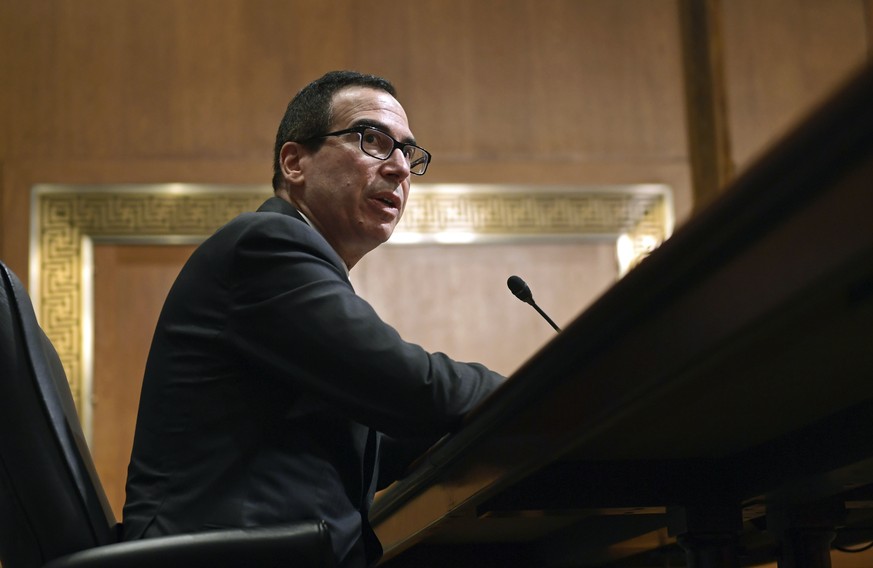 In this Feb. 14, 2018 photo, Treasury Secretary Steven Mnuchin testifies before the Senate Finance Committee on Capitol Hill in Washington. The Trump administration on Thursday imposed sanctions on 19 ...