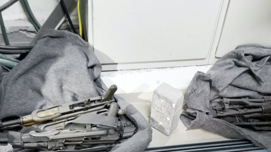 This image taken from a video released by the Israeli Defense Forces, Wednesday, Nov. 15, 2023, shows a cache of weapons the IDF says were found in a closet at the MRI center at al-Shifa hospital in G ...