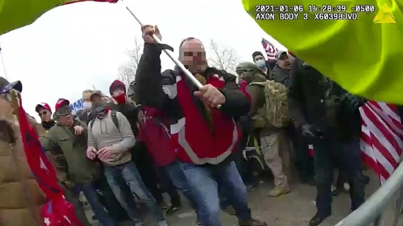 FILE - This still frame from Metropolitan Police Department body worn camera video shows Thomas Webster, in red jacket, at a barricade line at on the west front of the U.S. Capitol on Jan. 6, 2021, in ...