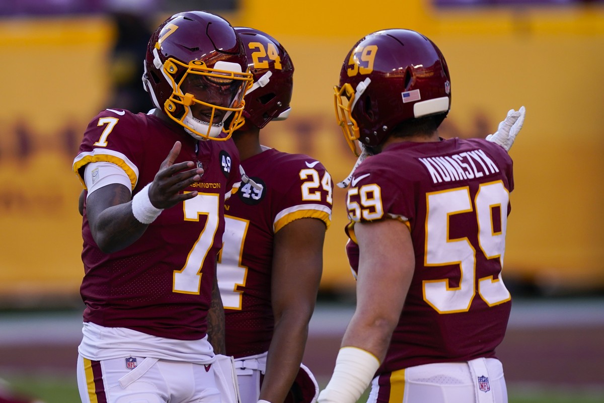Washington Football Team quarterback Dwayne Haskins (7) greets teammate linebacker Jordan Kunaszyk before the start of an NFL football game against the Carolina Panthers, Sunday, Dec. 27, 2020, in Lan ...