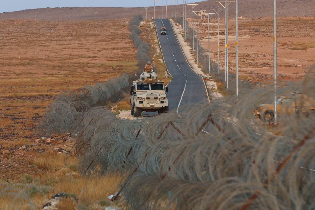 KEYPIX - A Jordanian Border Guard armored vehicle patrols along the fence on Jordan's eastern border with Syria near Deir al Gin, about 220 kilometers (137 miles) east of Amman, Tuesday, Oct. 6,  ...