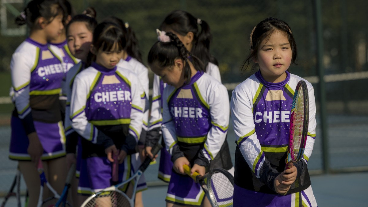 epa09618752 School girls practice tennis in the Wuxi Taihu Experimental Primary School in Wuxi, Jiangsu province, China, 03 December 2021. Wuxi Taihu Experimental Primary School is the base of the Nat ...