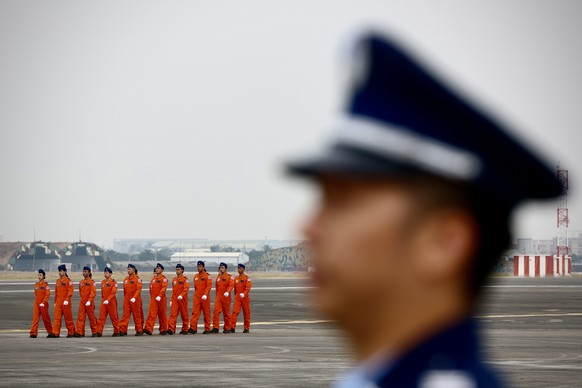 epaselect epa11005214 Taiwan Air Force pilots walk the tarmac during the Air Force Flight Training Command Formation Ceremony at an air base in Kaohsiung, Taiwan, December 1, 2023. As part of the ...
