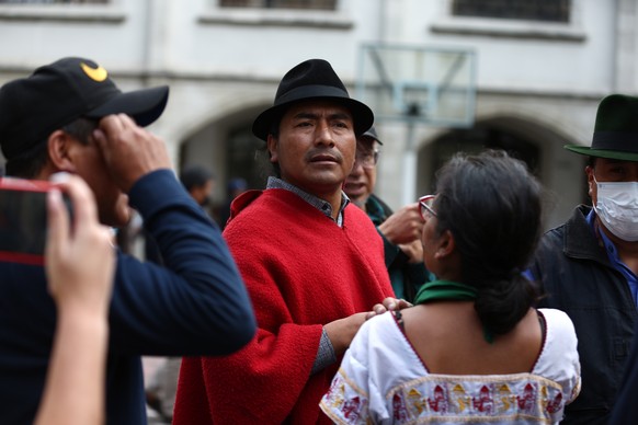 epa10039855 The president of the Confederation of Indigenous Nationalities of Ecuador (Conaie), Leonidas Iza (C), is seen at the Basilica of the National Vote after the announcement of the suspension  ...