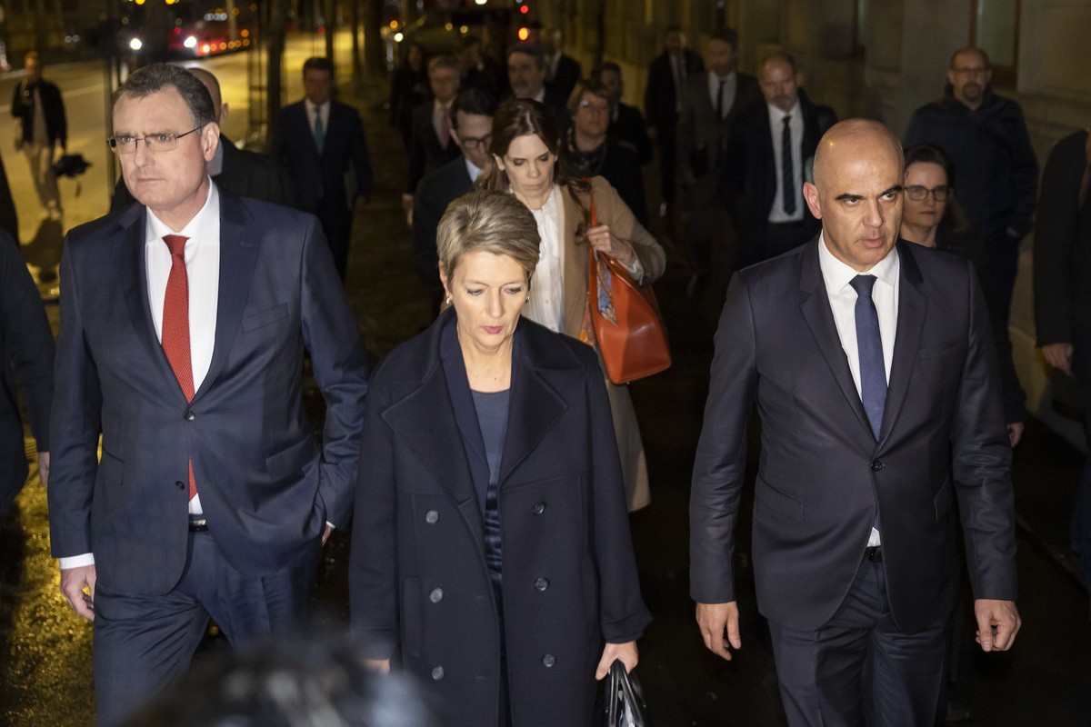 Swiss Federal President Alain Berset, right, Swiss Finance Minister Karin Keller-Sutter, center, and Thomas J. Jordan, Chairman Swiss National Bank, left, arrive for a press conference, on Sunday, 19  ...