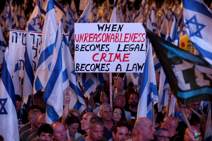 epa10734842 Protesters wave flags during an anti-government protest in Tel Aviv, Israel, 08 July 2023. Israeli activists protested against the government of Prime Minister Netanyahu and his nationalis ...