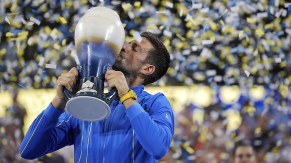 Novak Djokovic, of Serbia, kisses the Rookwood Cup as he poses for photos after defeating Carlos Alcaraz, of Spain, during the men&amp;#039;s singles final of the Western &amp;amp; Southern Open tenni ...