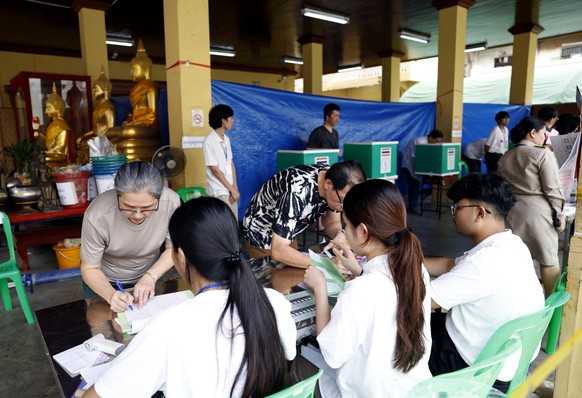epa12715134 Voters prepare cast their ballots during the general election at a polling station in Bangkok, Thailand, 08 February 2026. According to the Election Commission of Thailand (ECT), 52.9 mill ...