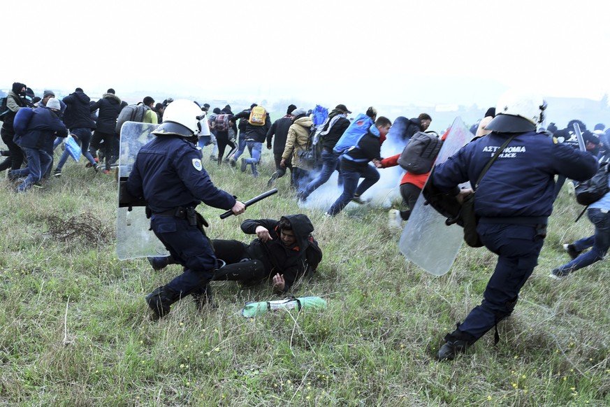 Riot police clash with protesting migrants outside a refugee camp in the village of Diavata, west of Thessaloniki, northern Greece, Saturday, April 6, 2019. Clashes between hundreds of protesting migr ...