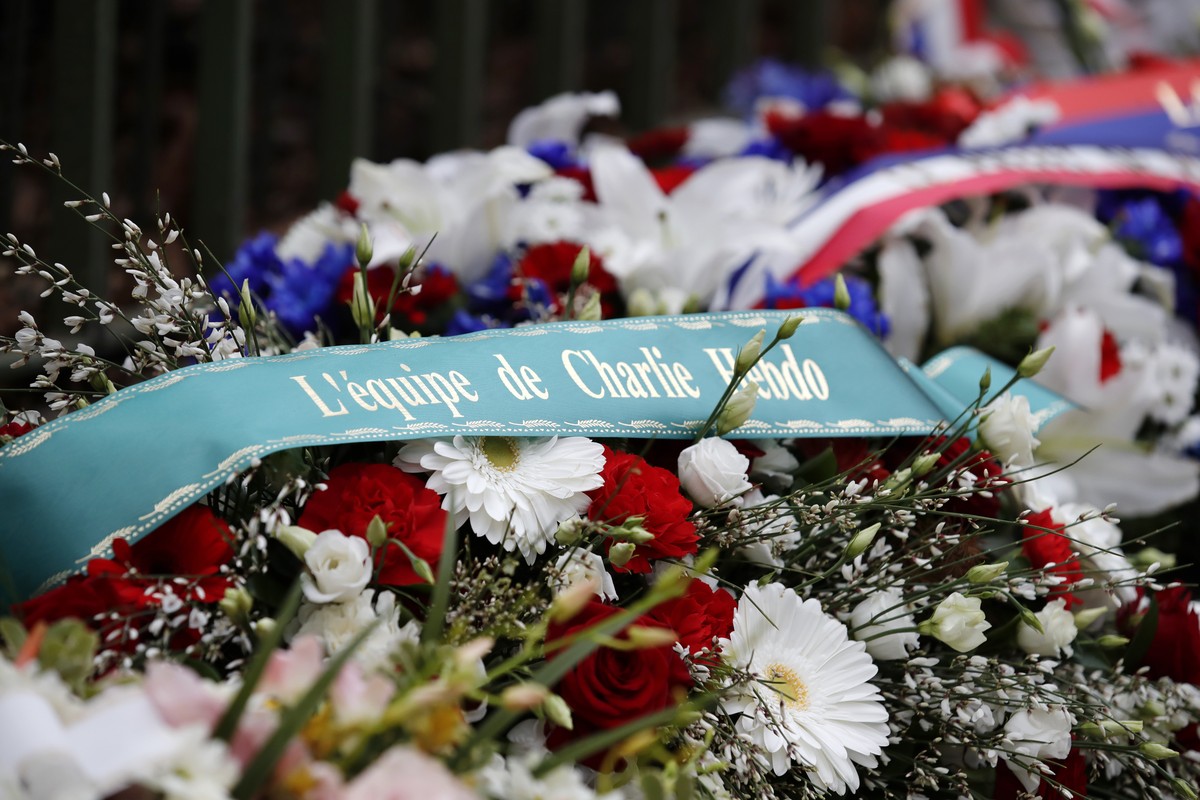 A wreath of flowers is seen outside the satirical newspaper Charlie Hebdo's former office, before a ceremony to mark the fourth anniversary of the attack in Paris, Monday, Jan. 7, 2019. 2015. Car ...
