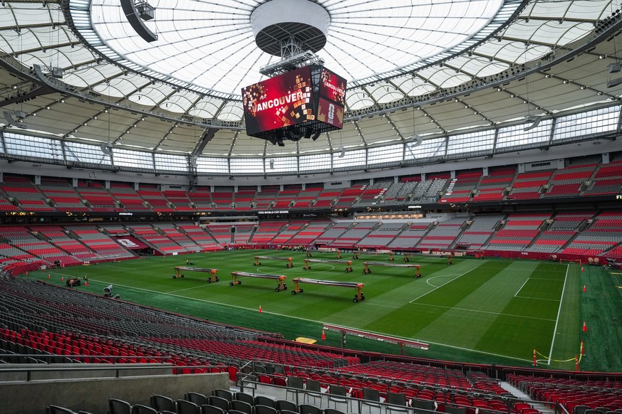 A worker cuts the grass that has been installed in B.C. Place stadium for the World Cup soccer tournament, Monday, June 8, 2026, in Vancouver, British Columbia. (Darryl Dyck/The Canadian Press via AP) ...
