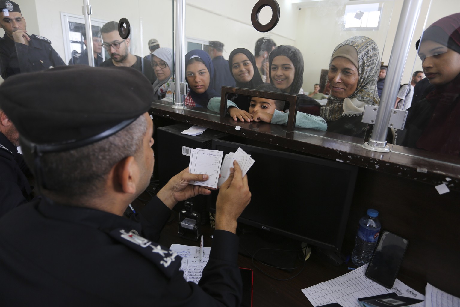 Palestinians with dual nationality register to cross to Egypt on the Gaza Strip side of the border crossing in Rafah on Thursday, Nov. 2, 2023. (AP Photo/Hatem Ali)