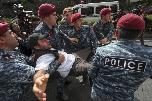 Police detain a demonstrator during a protest rally in Yerevan, Armenia, Thursday, May 5, 2022. The demonstrators marched, chanting &quot;Armenia without Nikol,&quot; referring to Prime Minister Nikol ...