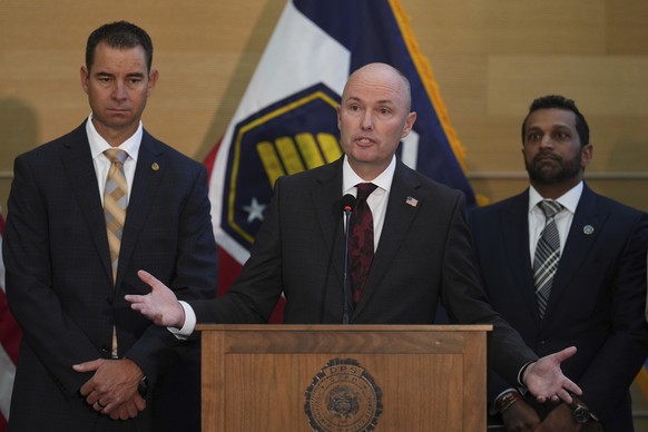 Utah Gov. Spencer Cox speaks at a news conference, as Utah department of public safety commissioner Beau Mason, left, and FBI Director Kash Patel listens, Friday, Sept. 12, 2025, in Orem, Utah,(AP Pho ...