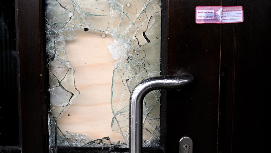 epa10513578 A police seal on the damaged door of the building that houses the Kingdom Hall of Jehovah's Witnesses, the day after a fatal shooting in Hamburg, Germany, March 10, 2023. According to Hamb…